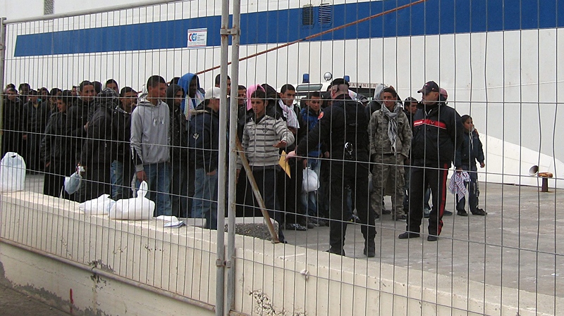 Would-be migrants believed to be from Tunisia are gathered at the port of the Sicilian island of Lampedusa, Italy, Friday, Feb. 11, 2011. (AP / Elio Desiderio)