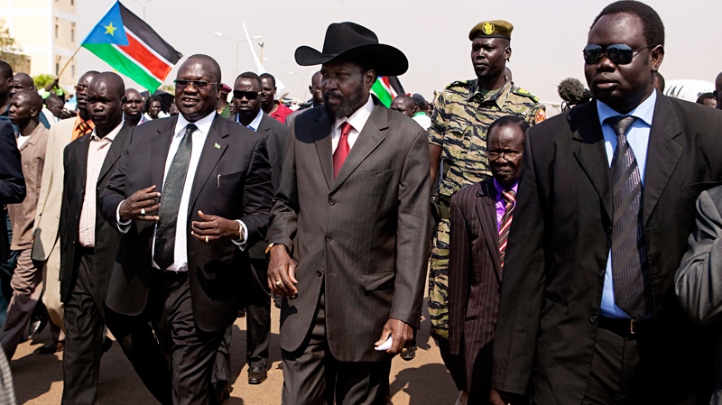 Salva Kiir Mayardit, the President of the Government of Southern Sudan, centre walks with Dr. Riek Machar, left, the Vice President, and James Wani Igga, centre right, the Speaker of the Southern Sudan Legislative Assembly, at the Juba International airport on his return from Khartoum where he attended the formal announcement of southern Sudan's referendum results on Tuesday, Feb. 8, 2011.(AP / Pete Muller)