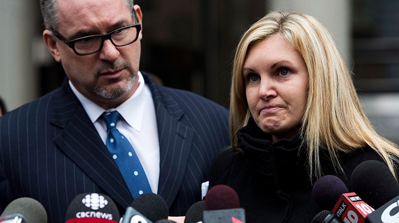 Christine Russell, widow of Sgt. Ryan Russell, reacts to the verdict in the case of Richard Kachkar as Toronto Police Association president Mike McCormack looks on in Toronto on Wednesday, March. 27, 2013. (Nathan Denette / THE CANADIAN PRESS)