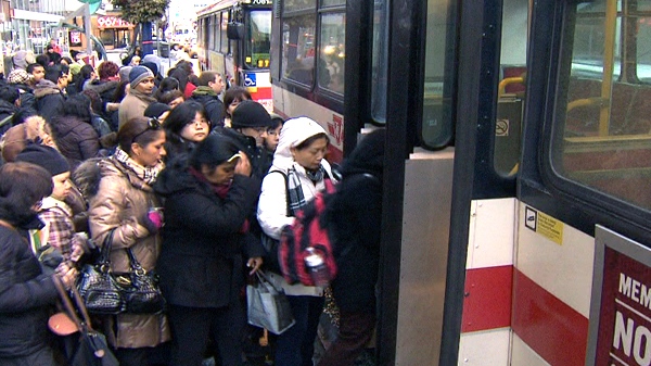 Passengers wait to board a shuttle bus after subway service went down on Monday, Feb. 14, 2011.