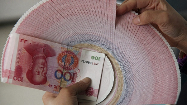A teller counts RMB banknotes at a bank in Linyi, east China, Jan. 25, 2011. (AP / Xinhua, Zhang Chunlei) 