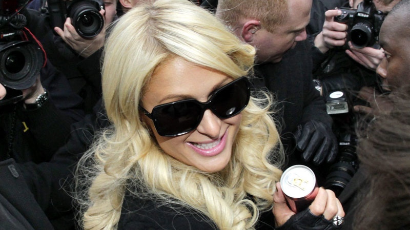 U.S. heiress Paris Hilton approaches the stock market in Frankfurt, central Germany, Thursday, Feb.3, 2011. Hilton has come to Frankfurt to promote a drinks brand. (AP Photo/Michael Probst)