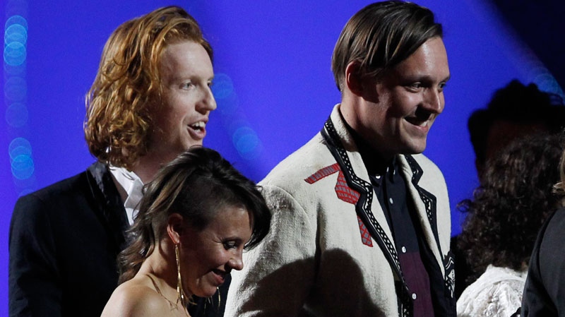 Arcade Fire react after winning the award for International Group on stage at the Brit Awards 2011 at The O2 Arena in London, Tuesday, Feb. 15, 2011. (AP / Joel Ryan)