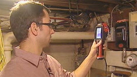 Eric Bjornson examines a home for signs of heat loss. 