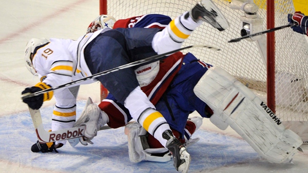 Buffalo Sabres' Tim Connolly crashes into Montreal Canadiens goalie Carey Price during first period NHL hockey action Tuesday, February 15, 2011 in Montreal. THE CANADIAN PRESS/Paul Chiasson