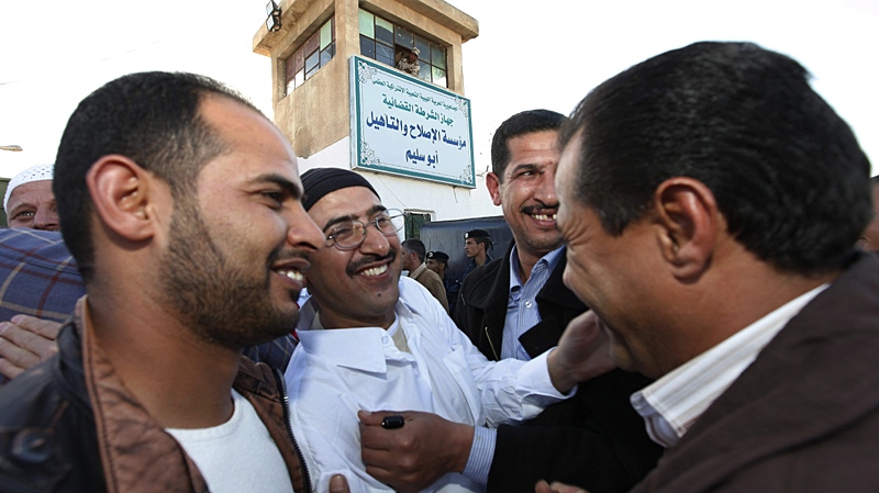 A Libyan Islamic prisoner, second left, is hugged by his relatives after he was released with a group of 110 prisoners from Abu Salim, Libya's most notorious prison, in Tripoli, Libya, Wednesday, Feb. 16, 2011. (AP / Abdel Magid Al Fergany)
