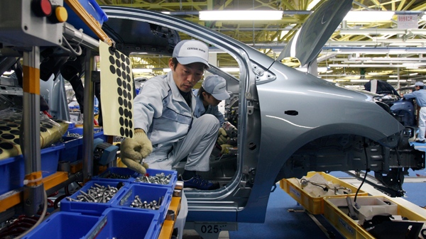 Workers assemble Yaris compact sedans, set for export to North America, on a newly opened assembly line at a plant of Toyota Motor Co.'s group company Central Motor Co. in Ohira in Miyagi Prefecture, northern Japan, Wednesday, Feb. 16, 2011. (AP / Koji Sasahara)