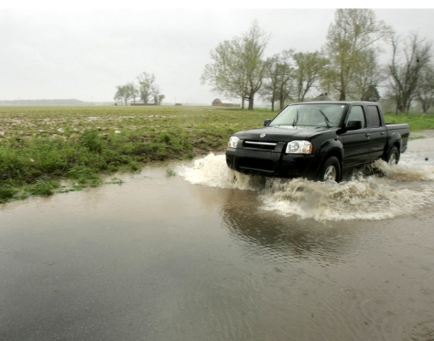 A truck is driven through high water flooding form a nearby soybean field near Scott, Ark., Thursday, April 10, 2008. (AP / Danny Johnston)