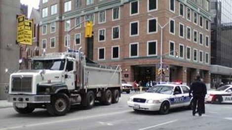 A man was transported to hospital without vital signs after being trapped under a dump truck at the corner of Laurier and Metcalfe streets, Wednesday, February 16, 2011. 