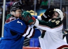 Colorado Avalanche defenseman Ryan O'Byrne (3) fights with Minnesota Wild defenseman Justin Falk (44) during the first period of an NHL hockey game on Saturday, March 16, 2013, in Denver. (AP Photo/Jack Dempsey)