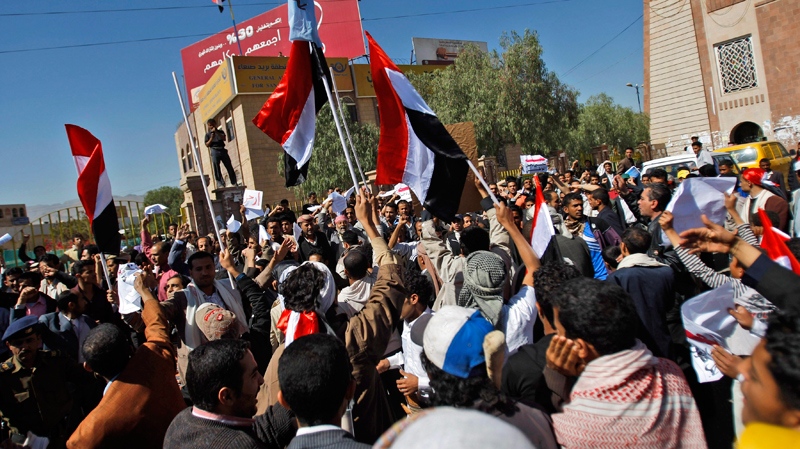 Supporters of the Yemeni government gather as they wave flags and chant slogans, in Sanaa, Yemen, Thursday, Feb. 17, 2011. (AP Photo/Hani Mohammed)