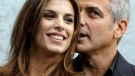 George Clooney hugs his girlfriend Elisabetta Canalis prior to the presentation of the Armani Spring-Summer 2011 fashion collection, during the fashion week in Milan, Italy, Monday, Sept. 27, 2010. (AP / Luca Bruno)