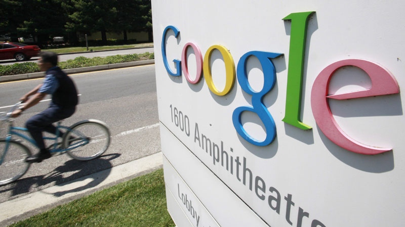 In this file photo made July 13, 2010, a Google worker rides a bike at the company's headquarters in Mountain View, Calif. (AP Photo/Paul Sakuma, file)