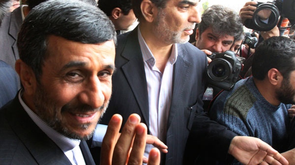 Iranian President Mahmoud Ahmadinejad, waves to the media as he leaves the parliament after he submitted next year's budget bill, in Tehran, Iran, Sunday, Feb. 20, 2011. (AP / Vahid Salemi)