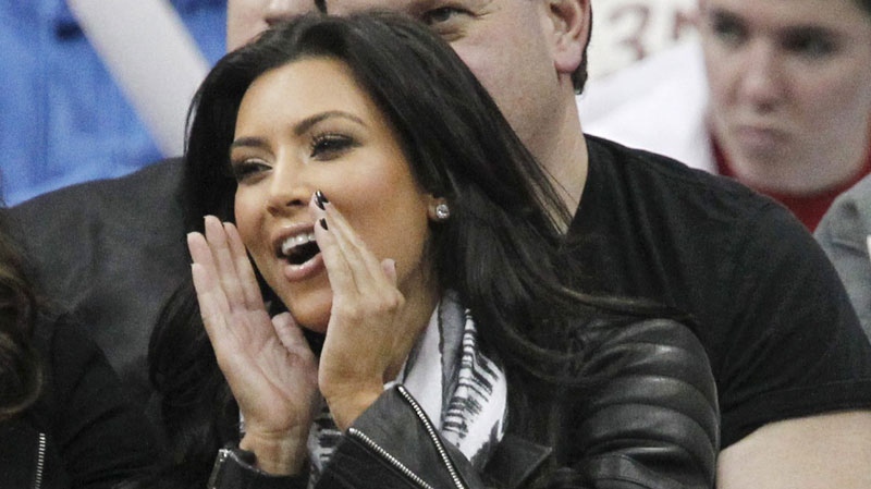 Actress Kim Kardashian shouts during the third quarter of an NBA basketball game between the New Jersey Nets and the Indiana Pacers, Sunday, Feb. 6, 2011, in Newark, N.J. (AP Photo/Julio Cortez)