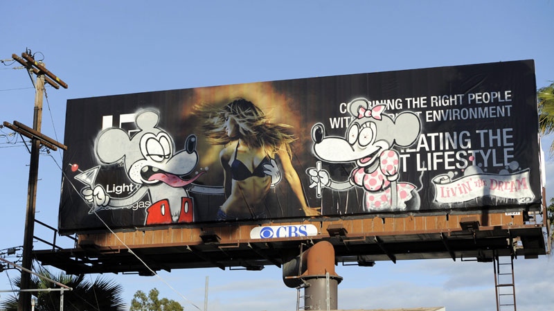 In this Feb. 16, 2011 photo, a billboard poster allegedly tagged by the graffiti artist Banksy is shown on Sunset Boulevard in Los Angeles. Banksy's film "Exit Through the Gift Shop" is nominated for an Academy Award for Documentary Feature at next week's Oscars ceremony in Los Angeles. (AP Photo/Chris Pizzello)