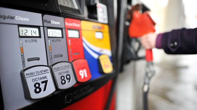 A motorist reaches for the pump at a gas station in Toronto on Thursday, Feb. 24, 2011. (Patrick Dell / THE CANADIAN PRESS)