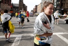 An unidentified Boston Marathon runner leaves the course crying near Copley Square following an explosion Monday, April 15, 2013. (AP Photo/Winslow Townson)