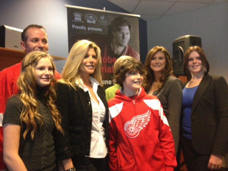 HDGH Foundation director Bill Marra (left) stands with family members of the late Bob Probert in Windsor, Ont., on April 16, 2013. (Rich Garton / CTV Windsor) 