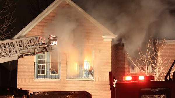 Emergency crews battle a fire in a home on Macrill Road, near Woodbine Avenue and Major Mackenzie Drive, at around 2:40 a.m. on Friday, Feb. 25, 2011. (Tom Stefanac / CTV News)
