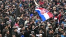 Protesters chant slogans and wave a Croatian flag during a protest in Zagreb, Croatia, Saturday, Feb. 26, 2011. (AP Photo/Darko Bandic)