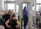 Passengers are scanned at a security checkpoint at Logan Airport in Boston using a millimeter wave body scanner, Wednesday, Oct. 24, 2012. (AP / Charles Krupa)