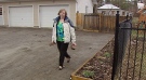 Kathy Dickenson examines ripped up driveway