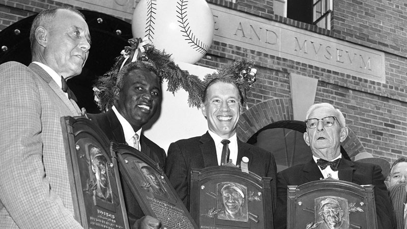 In this July 23, 1962, file photo, Hall of Famers, from left, Edd Roush, Jackie Robinson, Bob Feller and Bill McKechnie, hold the plaques presented to them in Cooperstown, N.Y. (AP Photo/File)