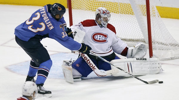 Montreal Canadiens goalie Carey Price (31) prepares to block a shot from Atlanta Thrashers defenseman Dustin Byfuglien (33) in the third period of an NHL hockey game in Atlanta, Tuesday, March 1, 2011. Montreal won 3-1. (AP Photo/John Bazemore)