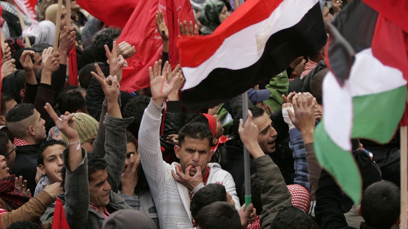 Palestinians demonstrators shout slogans during a demonstration marking the 42nd anniversary of the Democratic Front for the Liberation of Palestine(DFLP), in the West Bank city of Ramallah, Saturday, Feb. 26, 2011. (AP Photo/Majdi Mohammed)