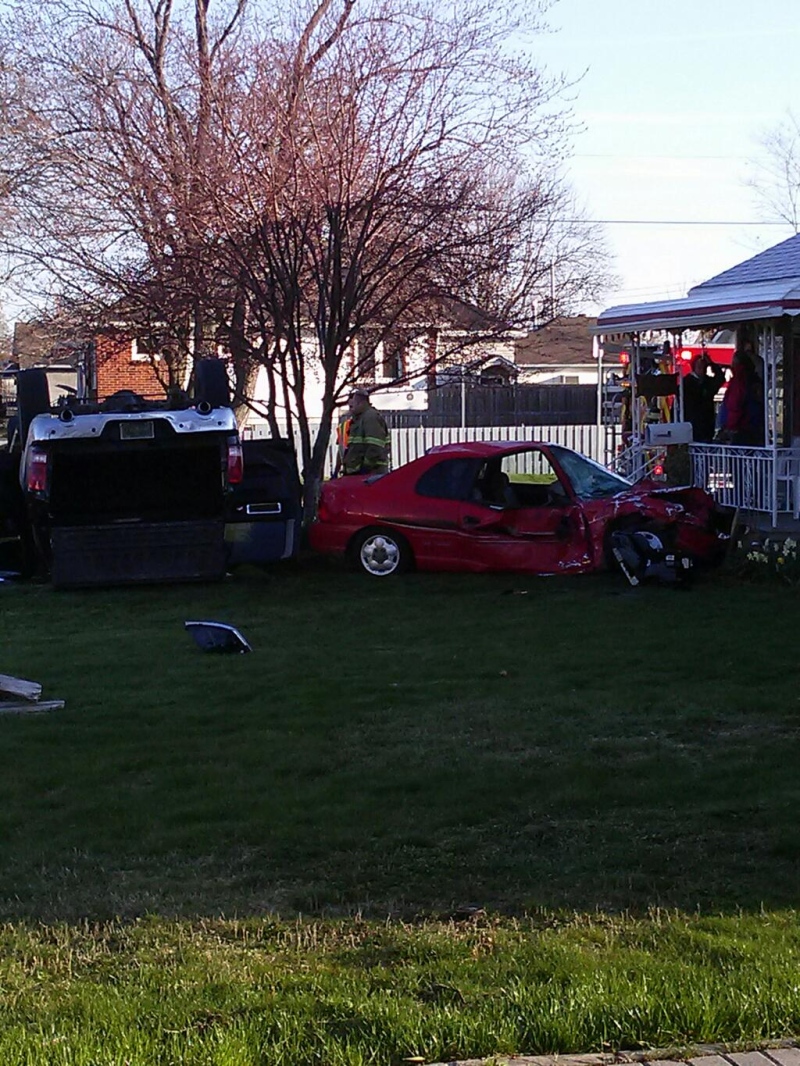 A Dodge Ram truck and Dodge Neon ended up on this front lawn at Meighan Road and Ypres Boulevard in Windsor, Ont. on Monday, April 22, 2013. (Arms Bumanlag / CKLW)