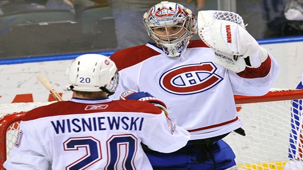 Montreal Canadiens goalie Carey Price (31) celebrates with teammate James Wisniewski (20) after they defeated the Florida Panthers 4-0 in an NHL hockey game in Sunrise, Fla., Thursday, March 3, 2011. (AP Photo/Steve Mitchell)