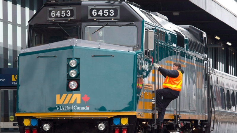 A Via Rail employee climbs aboard a locomotive at the train station in Ottawa on Monday, Dec. 3, 2012. (The Canadian Press/Adrian Wyld)