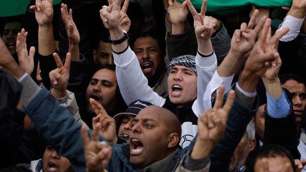 Anti-Libyan Leader Moammar Gadhafi protesters gesture as they shout anti-Gadhafi slogans during a protest after the Friday prayer at the court square, in Benghazi, eastern Libya, on Friday March 4, 2011. (AP / Hussein Malla)