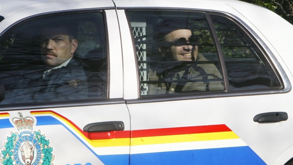 Thomas George Svekla, 38, smiles in the back of a police cruiser in Fort Saskatchewan, Alberta, Thursday, May 11, 2006. (THE CANADIAN PRESS/Ian Jackson)