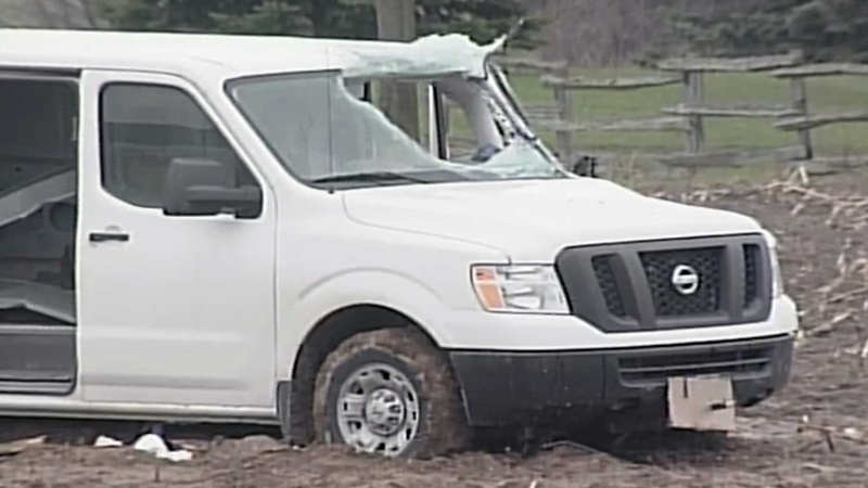 A van damaged when it was hit by debris, which killed the driver, is seen southeast of London, Ont. on Thursday, April 25, 2013.