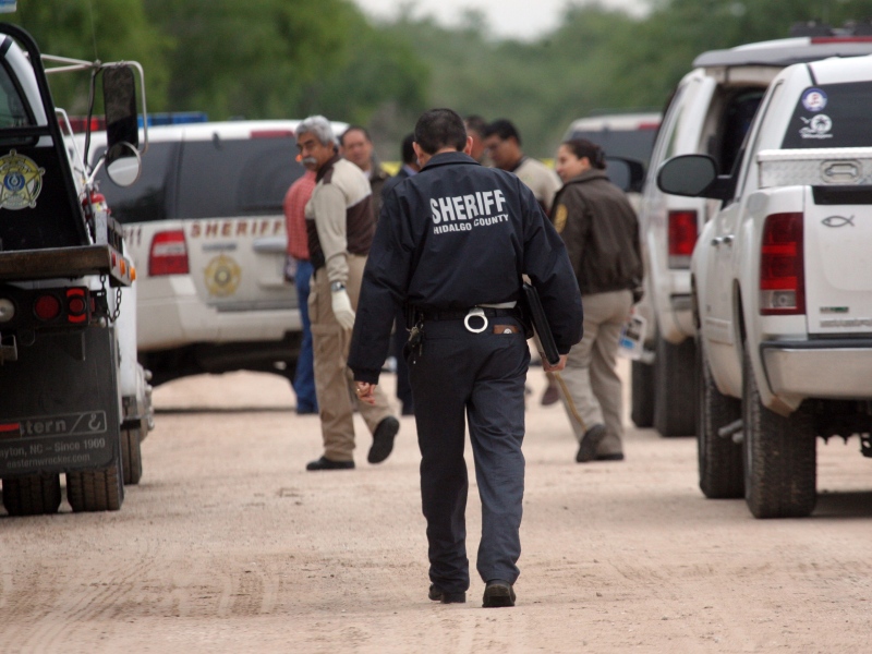Hidalgo County sheriff investigators converge on the scene north of Mission, Texas, on Thursday April 25, 2013. (The Monitor, Delcia Lopez)
