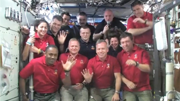 In this image taken from video released by NASA, all twelve Discovery and International Space Station crew members wave during a call from U.S. President Barack Obama Thursday, March 3, 2011. (AP / NASA)