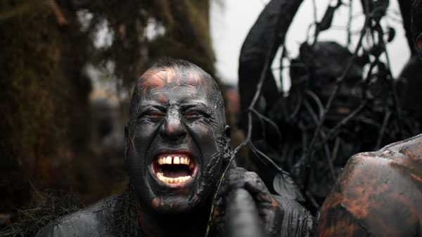 Covered by mud, a man participates in a mud party during Carnival celebrations in, Paraty, Brazil, Saturday, March 5, 2011. (AP / Rodrigo Abd)