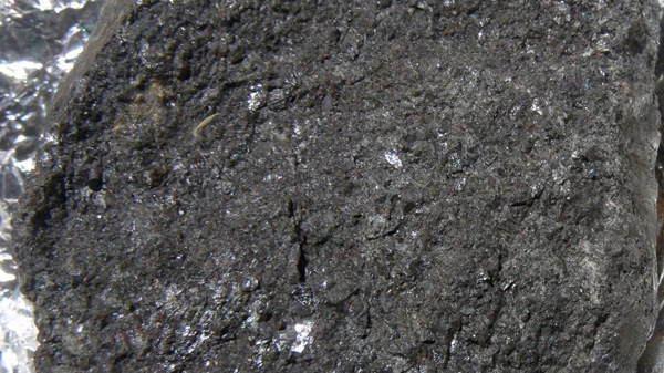 This photo released by NASA shows a typical example of a meteorite remnant linked to asteroid 2008 TC3, with a dark scruffy texture. (AP Photo/NASA)
