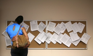 Examining a help wanted bulletin board. (AP / Mark Lennihan)