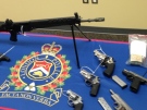 Guns seized by police on Friday are seen on display in London, Ont. on Monday, April 29, 2013. (Gerry Dewan / CTV London)
