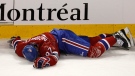 Montreal Canadiens' Max Pacioretty lays on the ice after taking a hit by Boston Bruins' Zdeno Chara during second period NHL hockey action Tuesday, March 8, 2011 in Montreal. (Paul Chiasson / THE CANADIAN PRESS)  