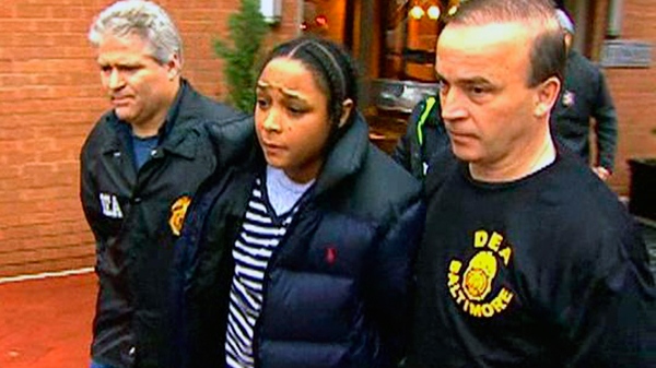 In this frame grab from video released by WBAL-TV 11, Drug Enforcement Administration agents escort Felicia 'Snoop' Pearson, who played a killer of the same name on 'The Wire,' as she was among dozens arrested in an early morning drug raid, Thursday, March 10, 2011, in Baltimore.
