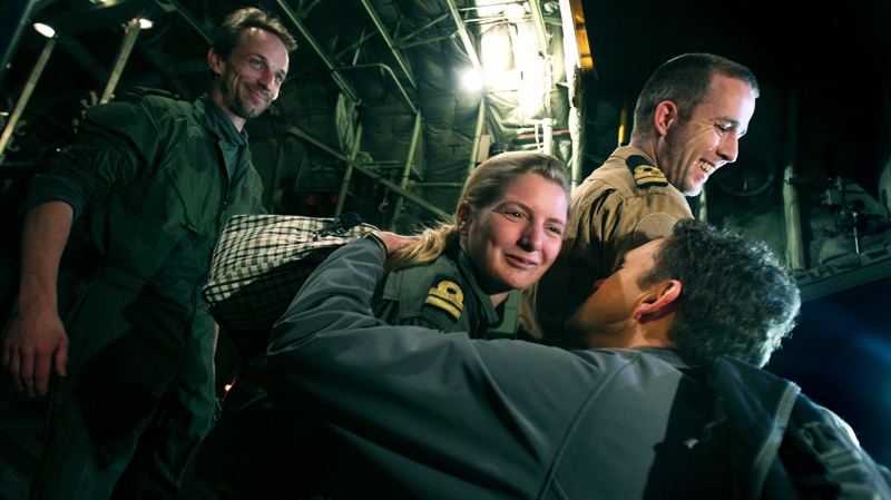 Three Dutch marines who were captured after a botched evacuation mission in Libya last month arrive at Athens' airport in Spata, Greece after they were released, early Friday, March 11, 2011. (AP / Petros Giannakouris)
