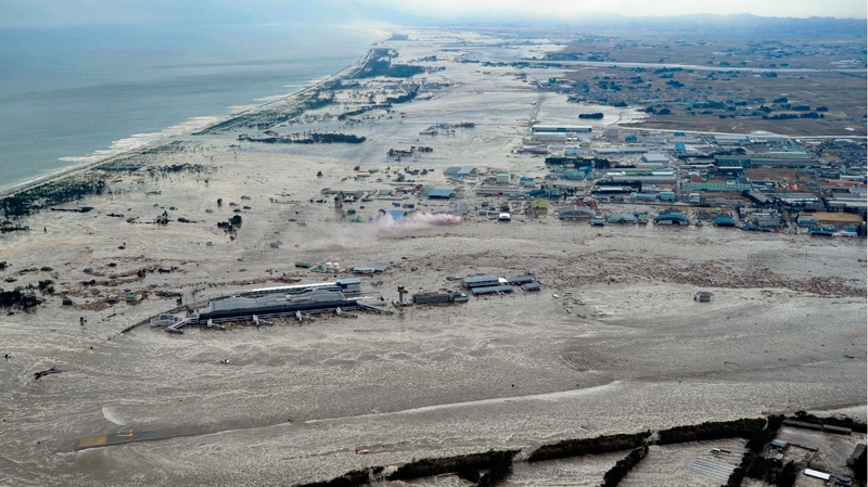 Earthquake-triggered tsunami sweeps the shore as Sendai Airport is surrounded by waters in Miyagi prefecture (state), Japan, Friday, March 11, 2011. The ferocious tsunami spawned by one of the largest earthquakes ever recorded slammed Japan's eastern coasts. (Kyodo News)