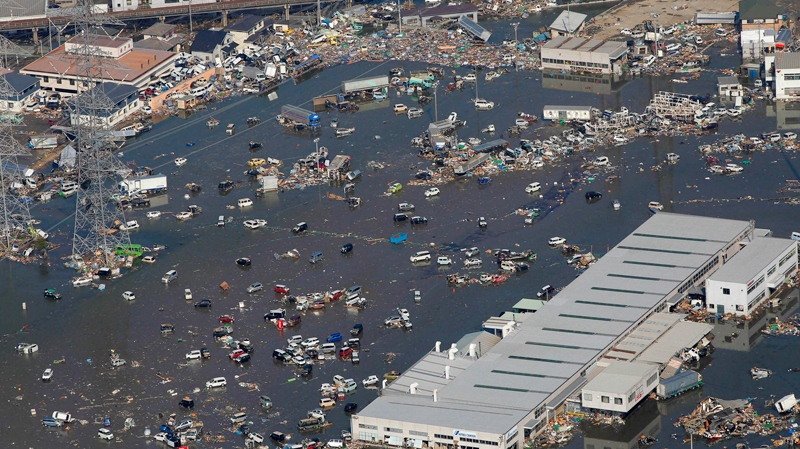 Part of a town gets flooded in Sendai, northern Japan, Saturday, March 12, 2011. Japan launched a massive military rescue operation Saturday after a giant, quake-fed tsunami killed hundreds of people and turned the northeastern coast into a swampy wasteland, while authorities braced for a possible meltdown at a nuclear reactor. (AP / Itsuo Inouye)