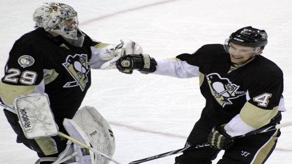 Pittsburgh Penguins' Zbynek Michalek (4) is congratulated by goalie Marc-Andre Fleury after scoring a goal in the third period of an NHL hockey game on Sunday, March 13, 2011, in Pittsburgh. The Penguins won 5-1. (AP Photo/Keith Srakocic)