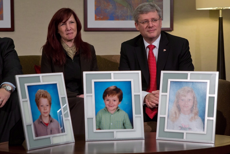 Darcie Clark's cousin Stacy Galt, left, sits with Prime Minister Stephen Harper in this February 2013 before he announced the Conservative government’s plan to provide courts with new powers to lock up people found not criminally responsible for their crimes due to mental problems. Darcie Clark's children Max, Cordon and Kaitlynne were killed by her ex-husband Allan Schoenborn in Merritt, B.C. in 2008. (Darryl Dyck/THE CANADIAN PRESS)