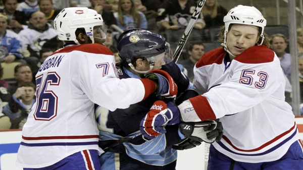 Montreal Canadiens' P.K. Subban (76) grabs Pittsburgh Penguins' Matt Cooke, center, as he tangles with Canadiens' Ryan White (53) during the second period of the NHL hockey game, Saturday, March 12, 2011, in Pittsburgh. The Canadiens won 3-0.(AP Photo/Keith Srakocic)